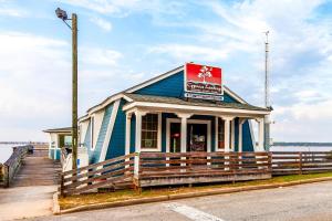 a building with a sign on it next to a pier at Red Roof Inn Santee in Santee