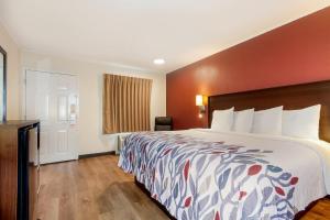 a hotel room with a large bed and a window at Red Roof Inn Santee in Santee