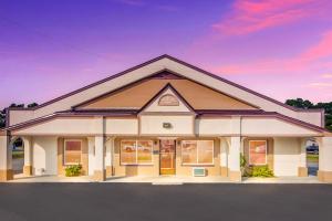 a large white building with a sky in the background at Red Roof Inn Santee in Santee