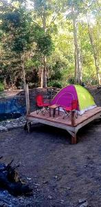 a tent and two chairs on a wooden bench at Eastdee Camping Ground in Lidlidda +36 photos