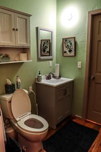 a bathroom with a toilet and a sink at Treasure State Hostel in Bozeman