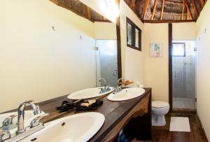 a bathroom with two sinks and a toilet at Yayum Bacalar in Bacalar +84 photos
