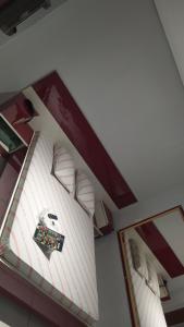 a room with a bed and two pictures on the wall at Hotel Progresso in Curitiba
