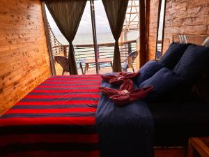 a bed in a room with a view of the ocean at B & B MAGGY_BEACH in Playa Blanca