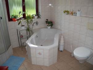 ein weißes Bad mit einer Badewanne und einem WC in der Unterkunft Holiday home in Bergen/Insel Rügen 2847 in Bergen auf Rügen