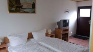 a bedroom with a white bed and a tv at Studio in Usedom - Insel Usedom 2319 in Welzin