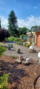 a garden with rocks and a gazebo at Apartment in Sehlen/Insel Rügen 3026 in Sehlen