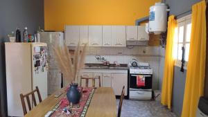 a kitchen with a table and a refrigerator at Dani I in Jesús María