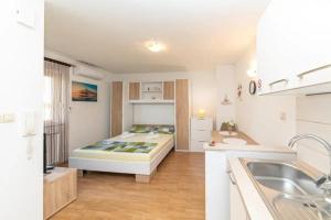 ein Schlafzimmer mit einem Bett in der Mitte eines Zimmers in der Unterkunft Apartments with a parking space Kastel Luksic, Kastela - 22071 in Kaštela