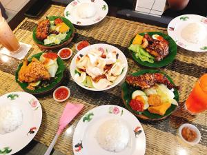 a table with plates of food on it at Ajang Hotel in Miri