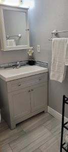 a bathroom with a sink and a mirror and towels at Cozy Condo For Rent In Melbourne Florida in Melbourne