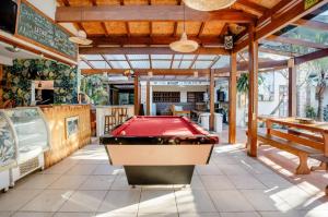 a pool table in the middle of a room at Tucano House in Florianópolis