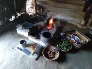 a fire pit with food and a bunch of food at Anokho in Nīmāj