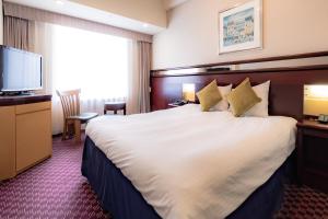 Кровать или кровати в номере Hotel Keihan Universal Tower