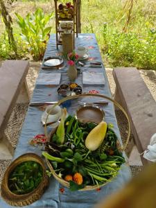 a blue table with a basket of vegetables on it at Anokho in Nīmāj