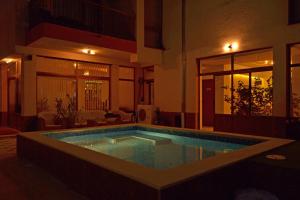 a swimming pool in the middle of a house at night at Svetlana Hotel in Byala