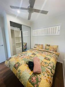 a bedroom with a bed with a stuffed animal on it at Cosy Sunlit Home Away from Home in Baulkham Hills