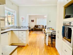 a kitchen and living room with a table and a couch at Rosehaven on Rosebud in Rosebud