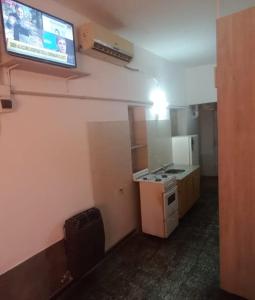 uma pequena cozinha com televisão na parede em Esquina La Argentina em San Luis