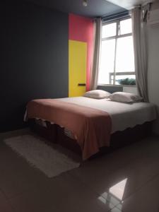 a bedroom with a bed with a colorful wall at Pousada Márcia Elizondo in Belém