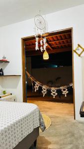 a bedroom with a bed and a window with a curtain at Quarto Sertão no Mar in Barra do Cunhau