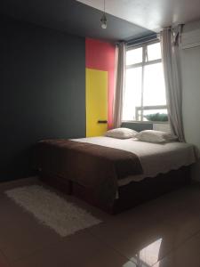 a bedroom with a bed with a colorful wall at Pousada Márcia Elizondo in Belém