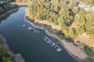 a group of boats are docked in a river at Rough River Lake Cabin Fishing in Fentress McMahan