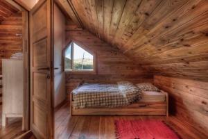 a bedroom in a log cabin with a bed in it at Holiday home in Smiljan 17134 in Smiljan