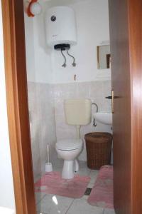 a bathroom with a toilet and a sink at Apartments in Vinisce 7372 in Vinišće