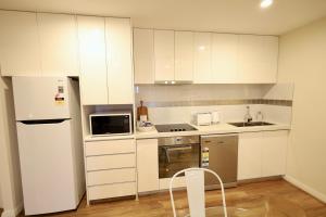 a kitchen with white cabinets and a white refrigerator at 10 Prime Location Living Midland 1br 1bth - SUPERHOG REQUIRED in Bellevue