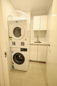 a washer and dryer in a kitchen with a sink at 10 Prime Location Living Midland 1br 1bth - SUPERHOG REQUIRED in Bellevue