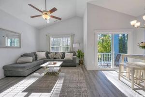 a living room with a couch and a ceiling fan at Brand New Home 3 Bed 25 bath, 4min walk to beach in Myrtle Beach