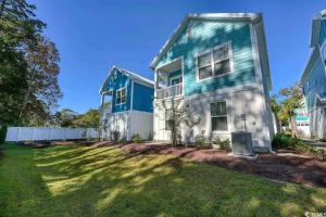 a blue and white house with a yard at Brand New Home 3 Bed 25 bath, 4min walk to beach in Myrtle Beach
