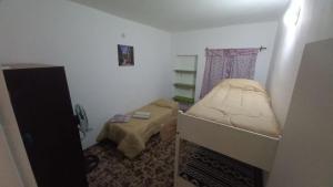 Giường trong phòng chung tại Casa LA ARGENTINA