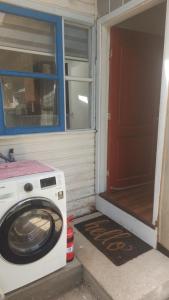 a washing machine sitting outside of a house at Camino de Luna, amplio y cómodo espacio in Valdivia