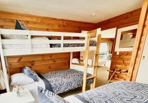 a bedroom with bunk beds in a cabin at Bach On Clyde in Mount Maunganui