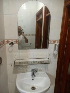 a person taking a picture of a sink in a bathroom at Calm And Peaceful in Marrakesh