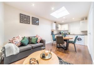 a living room with a couch and a table at 2 Bedroom Apartment in Perfect Location in Enfield Lock