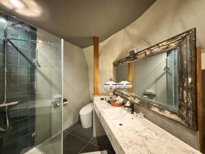 a bathroom with a sink and a shower and a mirror at villa福座 in Furusan