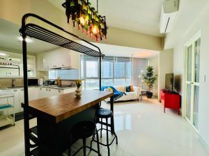 a kitchen with a table and chairs in a room at Luxury 2BR with Balcony Suite 8 - City View in Manila
