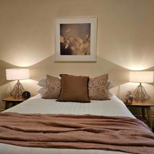 a bedroom with a large bed with two lamps at Cobb & CoHouse -Luxury Large Home BendigoCBD in Bendigo
