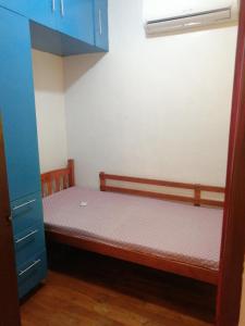 a small bedroom with a bunk bed and blue cabinets at Ruiz Domicile in Kawit