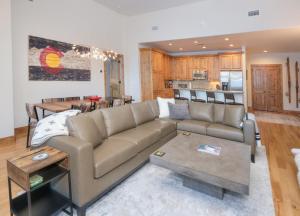 a living room with a couch and a kitchen at Beaver Creek Landing A406 condo in Avon