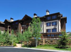 a large apartment building with a stone wall at Beaver Creek Landing A406 condo in Avon