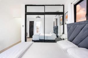 a bedroom with two beds and a large window at Residencial García apt 5 in La Romana