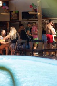 un grupo de personas sentadas en mesas en un restaurante en Tucano House, en Florianópolis