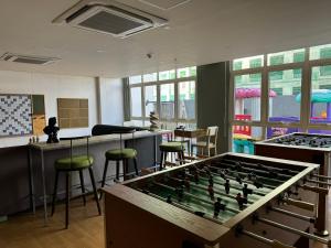 a room with a foosball table and stools at JAZ Stays Bacolod in Bacolod