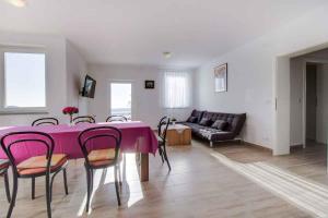 a living room with a table and chairs and a couch at Apartment in Cunski - Insel Losinj 15045 in Cunski