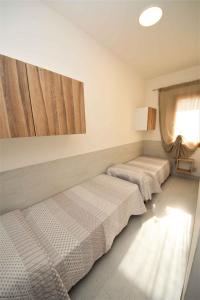 Habitación con 2 camas y ventana en Apartments in Rosolina Mare 33313 en Rosolina Mare