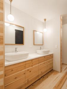 a bathroom with two sinks and a mirror at HATAYA Cafe&Hostel in Kyotango